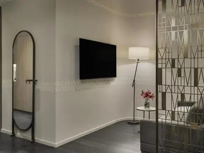 a living room with a television on a wall at SLS LUX Brickell in Miami
