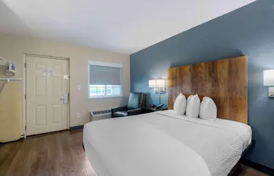 a hotel room with a bed and a chair at Extended Stay America Suites - Miami - Airport - Doral in Miami