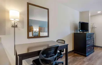 a room with a desk with a mirror and a chair at Extended Stay America Suites - Miami - Airport - Doral in Miami