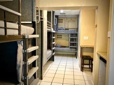 a hallway with bunk beds in a small room at Sheridan Hostel in Dania Beach