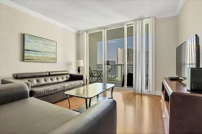 a living room with a couch and a television at THE TIDES 1 bedroom apt 10 floor WE ARE ON THE BEACH! in Hollywood