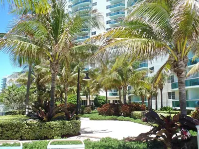a resort with palm trees in front of a building at THE TIDES 1 bedroom apt 10 floor WE ARE ON THE BEACH! in Hollywood