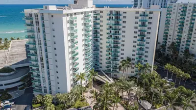 an aerial view of a large white building with palm trees at THE TIDES 1 bedroom apt 10 floor WE ARE ON THE BEACH! in Hollywood
