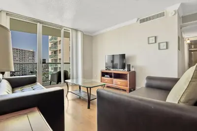 a living room with a couch and a tv at THE TIDES 1 bedroom apt 10 floor WE ARE ON THE BEACH! in Hollywood