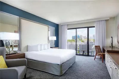 a hotel room with a large bed and a balcony at Bahia Mar Fort Lauderdale Beach - DoubleTree by Hilton in Fort Lauderdale