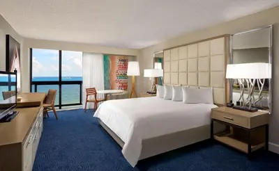 a hotel room with a large bed and a desk at Bahia Mar Fort Lauderdale Beach - DoubleTree by Hilton in Fort Lauderdale
