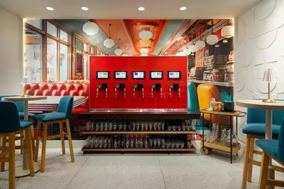 a restaurant with a red wall with wine bottles at Hotel Continental Miami Beach, Tapestry Collection by Hilton in Miami Beach