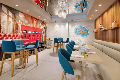 a restaurant with blue chairs and a dining room at Hotel Continental Miami Beach, Tapestry Collection by Hilton in Miami Beach