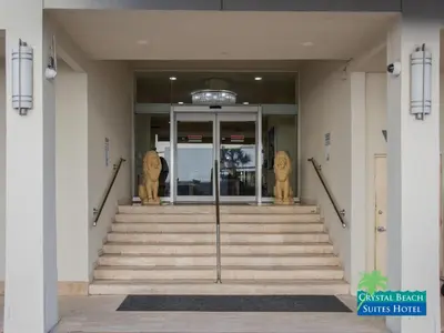 a lobby of a building with stairs and two statues at Crystal Beach Suites Miami Oceanfront Hotel in Miami Beach