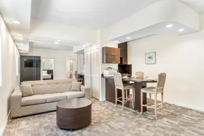 a living room with a couch and a table at Crystal Beach Suites Miami Oceanfront Hotel in Miami Beach