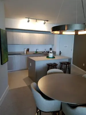 a kitchen with a table and some chairs and a counter at Rent in LYFE Resort in Hollywood