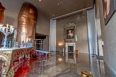 a room with a fireplace and a painting on the wall at ICON Brickell residences in Miami