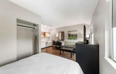a bedroom with a bed and a living room at Extended Stay America Premier Suites - Miami - Airport - Miami Springs in Miami