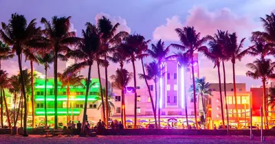 a building with palm trees in front of it at Oceanview Private Condo at 1 Hotel & Homes -906 in Miami Beach