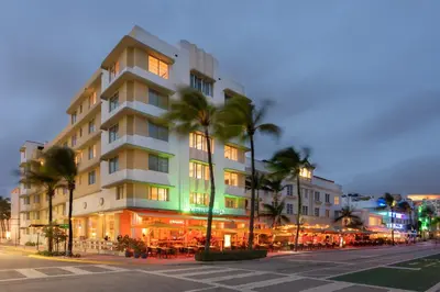 a building with palm trees in front of a street at Eurostars Winter Haven Miami Beach in Miami Beach