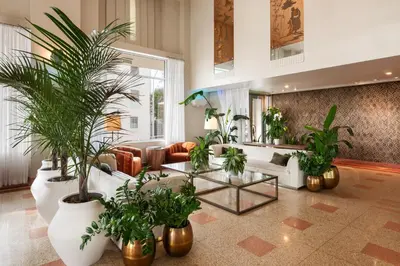 a living room with a couch and a table with plants at Eurostars Winter Haven Miami Beach in Miami Beach