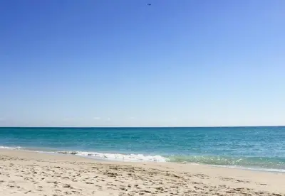 a sandy beach with the ocean in the background at Ocean Reserve Condominium in Miami Beach