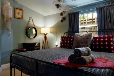 a bedroom with a bed with a large window at The Captain's Quarters - Home & Guesthouse in Fort Lauderdale