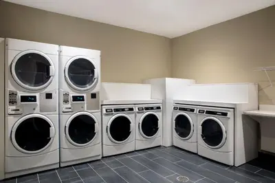 four washers and dryers in a laundry room at Candlewood Suites - Miami Exec Airport - Kendall by IHG in Kendall
