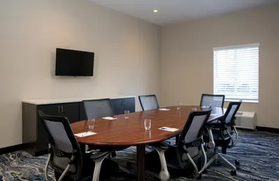 a conference room with a wooden table and chairs at Candlewood Suites - Miami Exec Airport - Kendall by IHG in Kendall