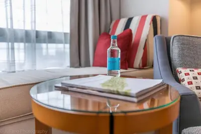 a bottle of alcohol sitting on a table in a living room at Signature Suite at Four Seasons Residences - Limited Time Offer in Miami