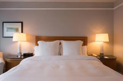 a bedroom with a bed with two lamps on it at Signature Suite at Four Seasons Residences - Limited Time Offer in Miami