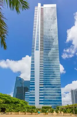 a tall skyscraper in a city with a blue sky at Signature Suite at Four Seasons Residences - Limited Time Offer in Miami