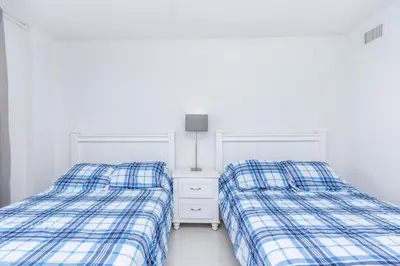two beds sitting next to each other in a bedroom at Ocean Reserve Sunny Isles in Miami Beach