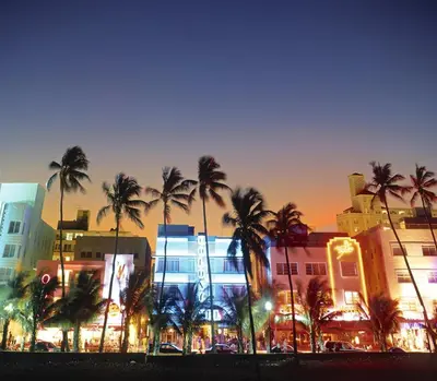 a group of palm trees in front of a building at 2 Bedroom Ocean Drive Newly Renovated in Miami Beach