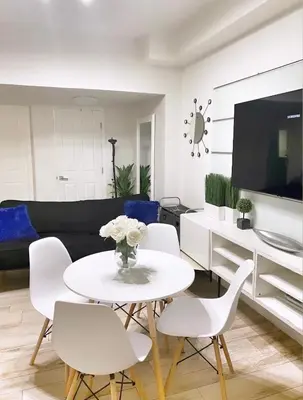 a living room with a white table and white chairs at 2 Bedroom Ocean Drive Newly Renovated in Miami Beach