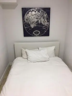 a bedroom with a white bed with a map on the wall at 2 Bedroom Ocean Drive Newly Renovated in Miami Beach