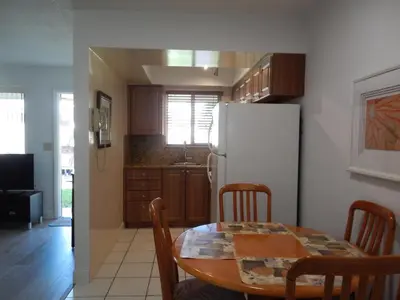 a kitchen with a table and a white refrigerator at Shell Motel Hollywood in Hollywood