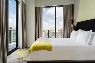 a bedroom with a large bed and large windows at Hyde Suites Midtown Miami in Miami