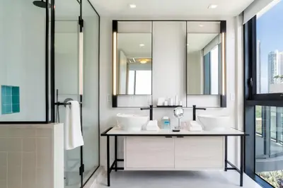 a bathroom with two sinks and a mirror at Hyde Suites Midtown Miami in Miami