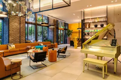 a living room with a piano and furniture at Hyde Suites Midtown Miami in Miami