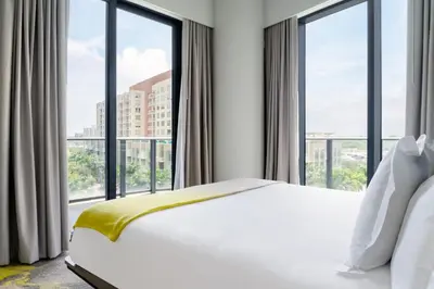 a bedroom with a bed and large windows at Hyde Suites Midtown Miami in Miami