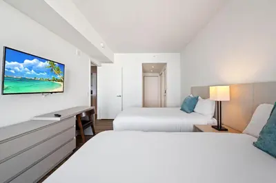 a hotel room with two beds and a tv at Lyfe Residence Building - Private apts over the beach in Hollywood