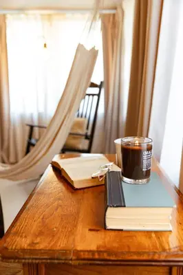a cup of coffee sitting on top of a book on a table at Casa del Ojo- Heated Pool - 3 King beds in Fort Lauderdale