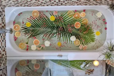 an open refrigerator with oranges and flowers on it at Casa del Ojo- Heated Pool - 3 King beds in Fort Lauderdale