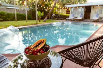 a bowl of fruit on a table next to a pool at Casa del Ojo- Heated Pool - 3 King beds in Fort Lauderdale