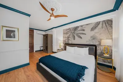 a bedroom with a bed and a ceiling fan at Hotel St. Michel in Miami