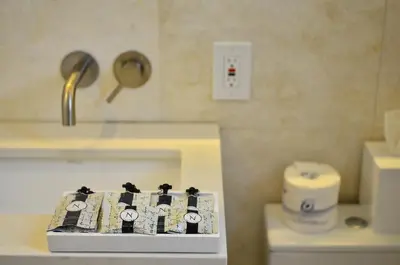 a remote control sitting on a counter in a bathroom at Hotel St. Michel in Miami