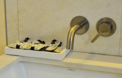 a bathroom sink with a faucet on a counter at Hotel St. Michel in Miami