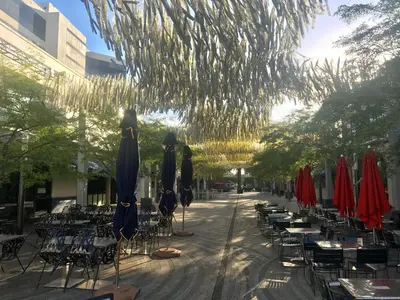 a street with tables and chairs and umbrellas at Hotel St. Michel in Miami