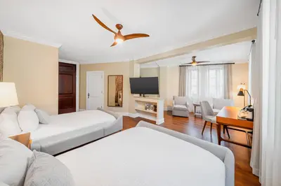 a hotel room with two beds and a television at Hotel St. Michel in Miami