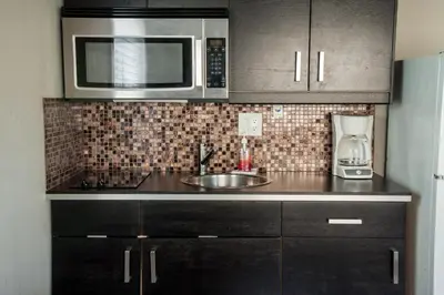 a kitchen with a sink and a microwave at Sun Beach Inn in Hollywood