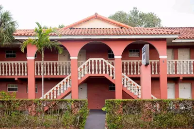 a large red building with a wooden deck at Gables Inn in Miami
