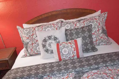 a bed with a bunch of pillows on it at Gables Inn in Miami