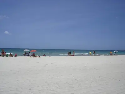 a group of people on a beach with the ocean at Casablanca on the beach, Oceanfront Studio Miami Beach in Miami Beach