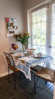 a dining room table with a blue and white table cloth at The Wild Rose in Miami